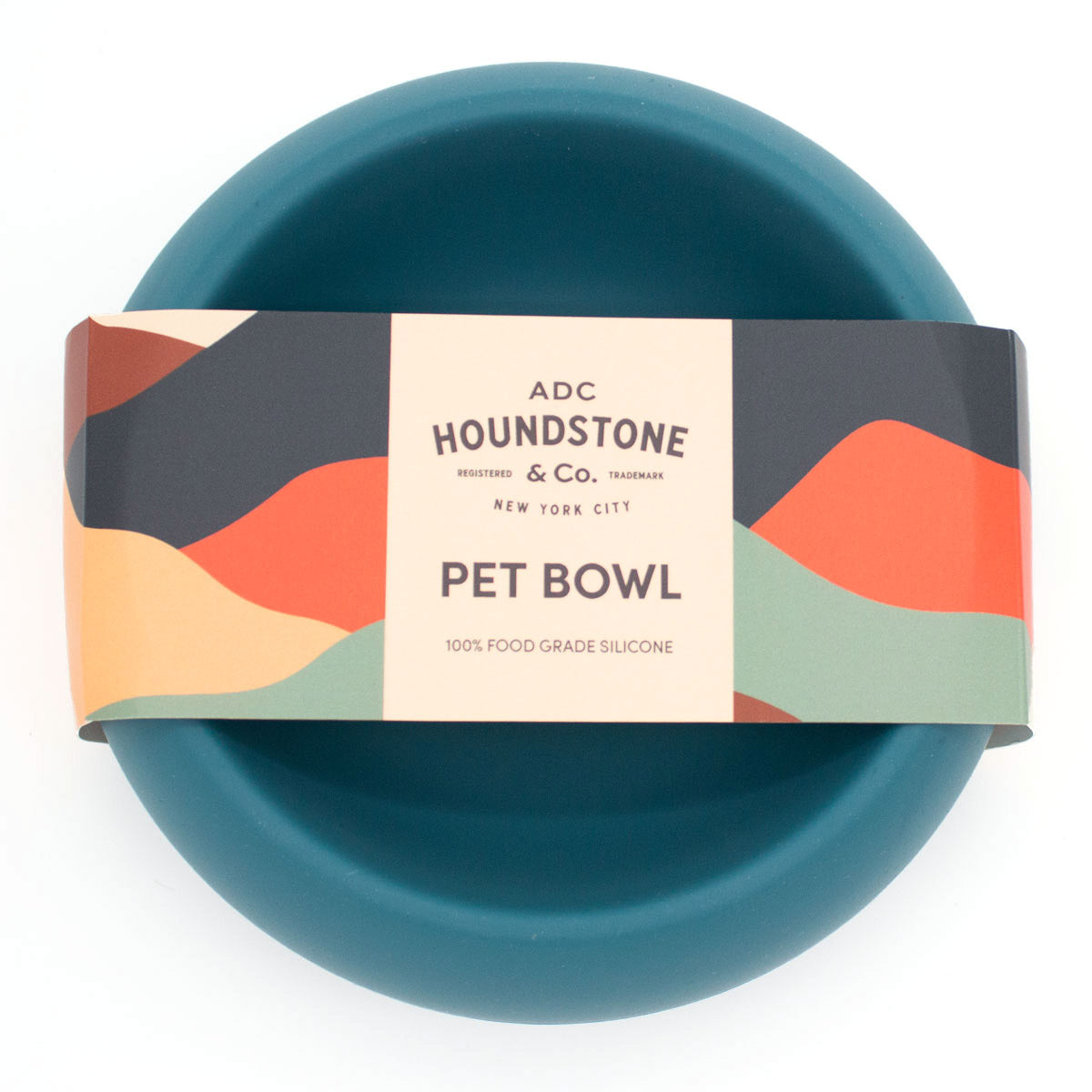 Teal dog bowl with colorful packaging featuring 'ADC Houndstone & Co' on a white background
