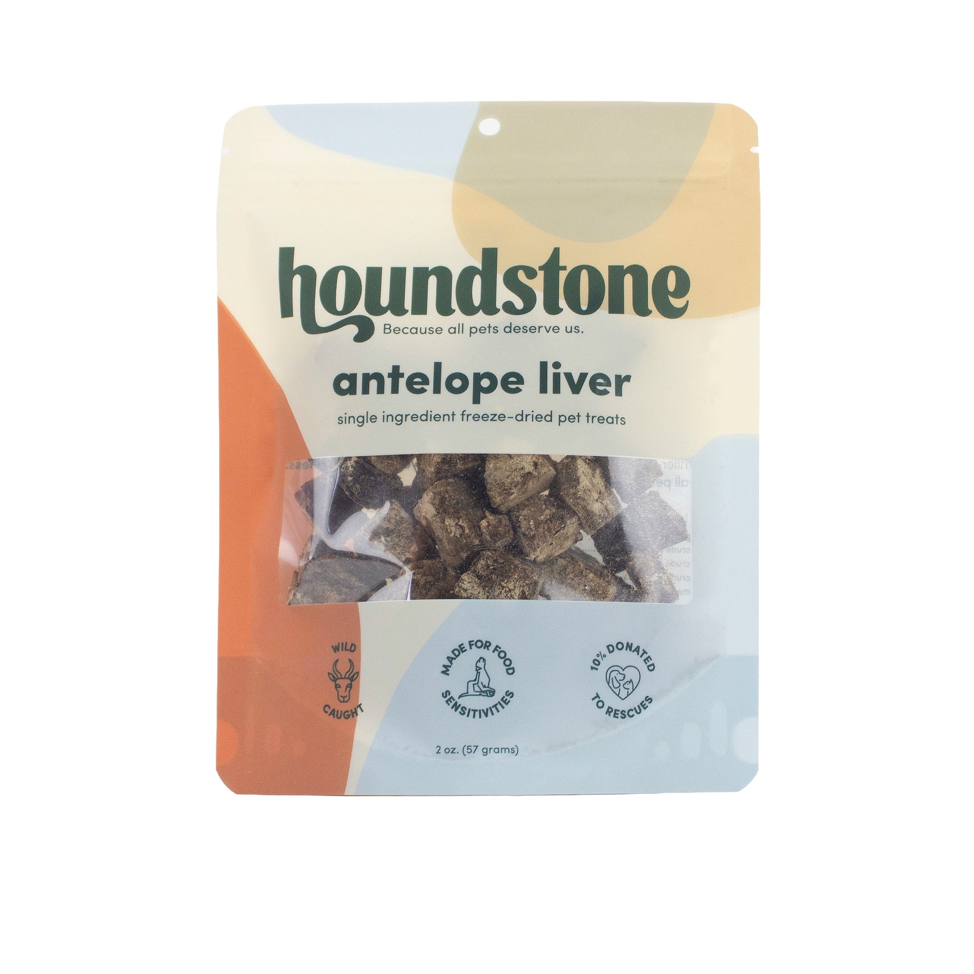 A 2 oz bag of Houndstone Antelope Liver single ingredient freeze-dried cat treats. The packaging features a modern abstract design with beige, orange, and light blue shapes, and a clear window showing the dark brown freeze-dried cat treats inside.