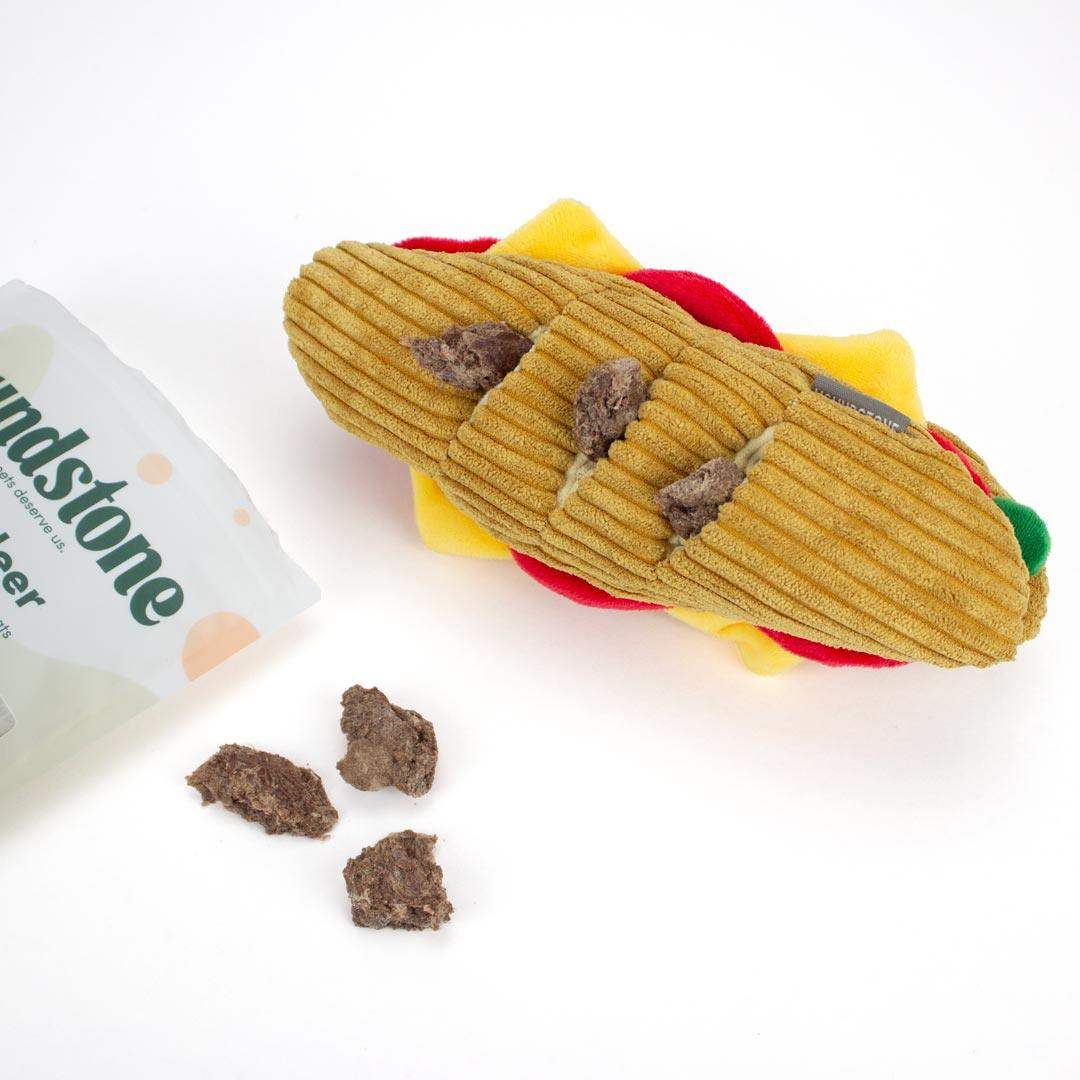 Interactive Dog toys shaped like a  sandwich with a package labeled 'Houndstone' on a white background