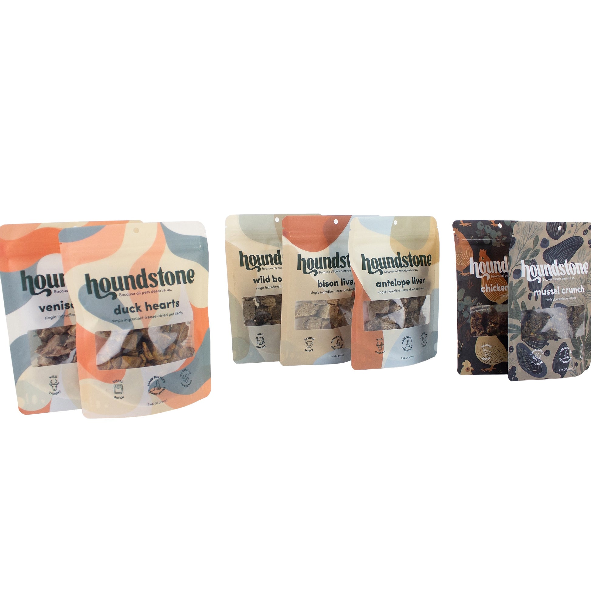 Six Houndstone cat treat pouches arranged in a row on a plain white background, including venison, duck hearts cat treats, wild boar, bison liver cat treats, antelope liver cat treats. 