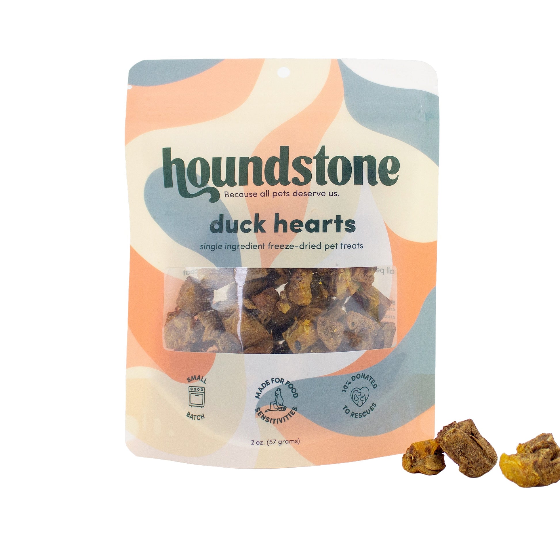 A package of Houndstone Duck Hearts single-ingredient freeze-dried dog treats, shown on a white background with three treats placed in front of the bag.