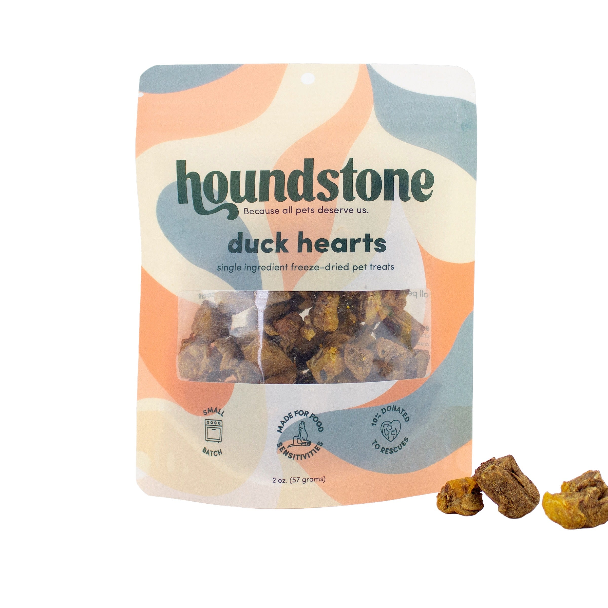 A package of Houndstone Duck Hearts single-ingredient freeze-dried dog treats, shown on a white background with three treats placed in front of the bag.