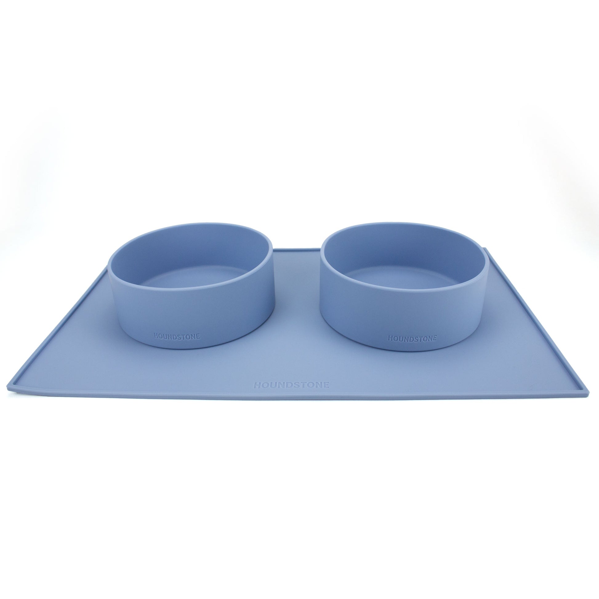 two silicone dog food bowls on top of a houndstone dog bowl mat blue