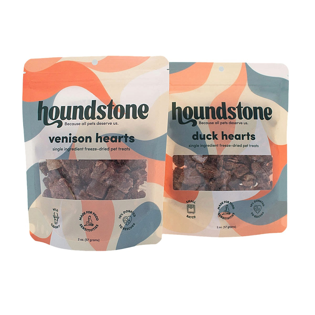 Two Houndstone cat treat pouches on a white background: one labeled venison hearts and one labeled duck hearts freeze dried cat treats. The packaging has a colorful abstract design in orange, cream, and blue-gray, with a clear window showing the freeze-dried cat treats inside.