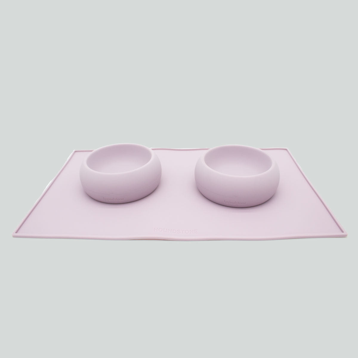2 mauve Houndstone dog bowls on a dog food mat on a white background