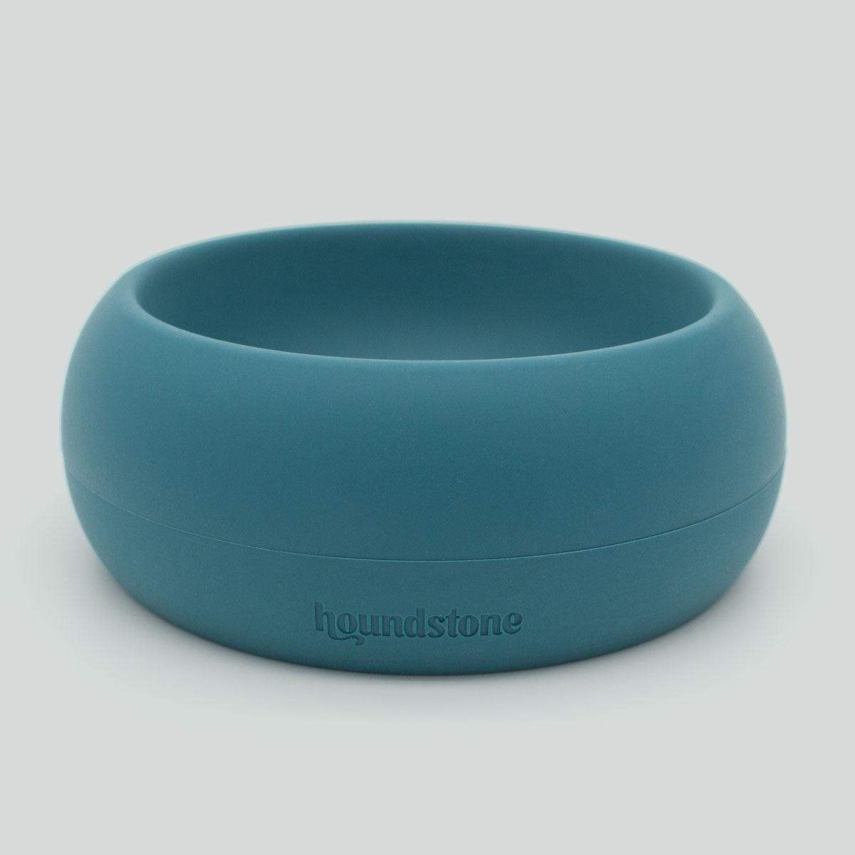 Teal dog bowl with 'houndstone' branding on a light gray background