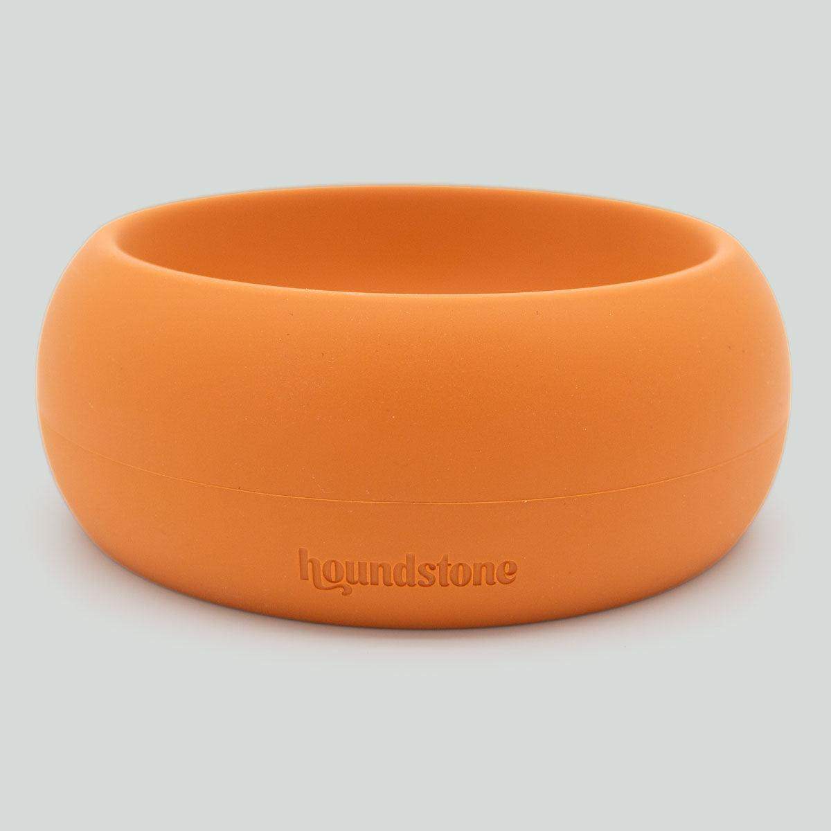 Orange dog bowl with 'houndstone' branding on a light gray background