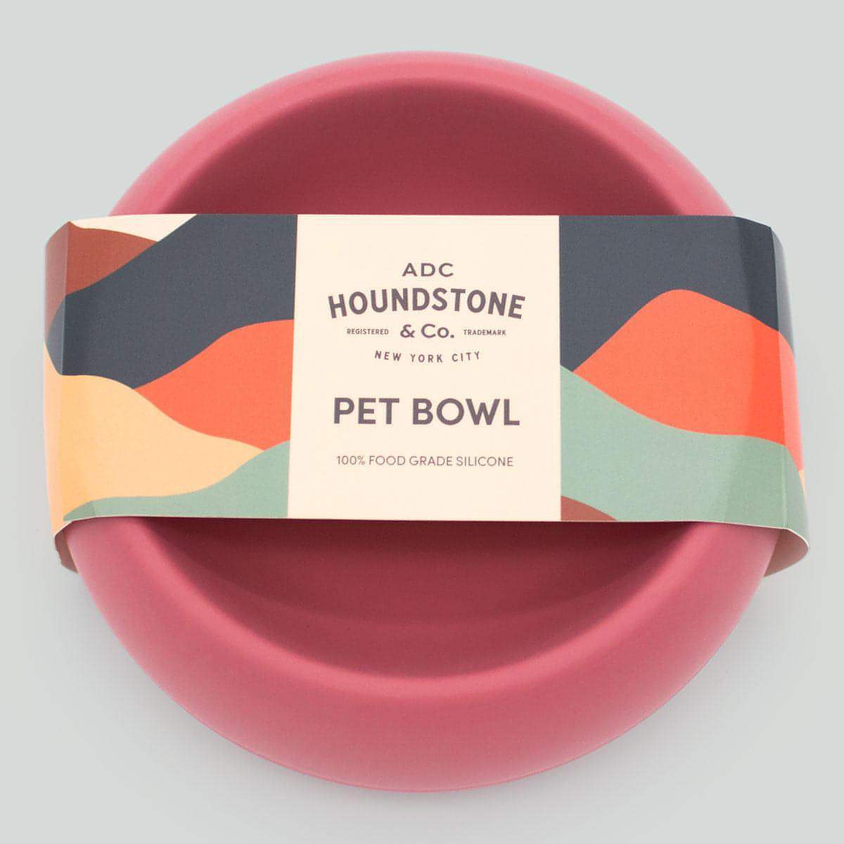 Pink dog bowl with Houndstone & Co packaging on a light gray background