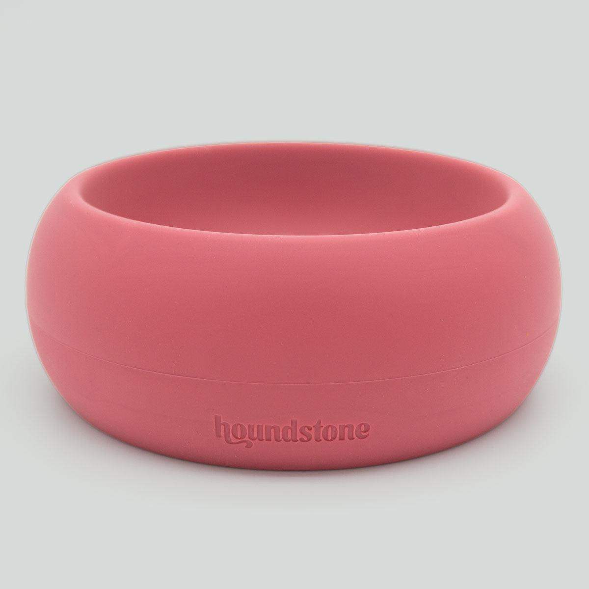 Pink dog bowl with 'houndstone' branding on a light gray background