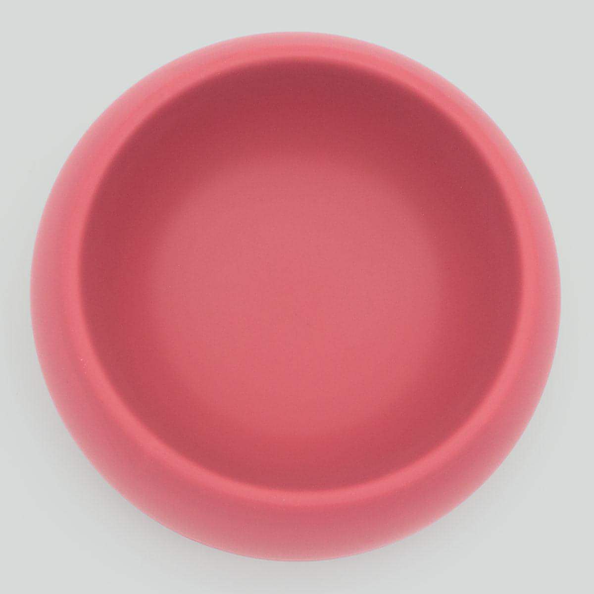 pink silocone dog bowl on a light gray background
