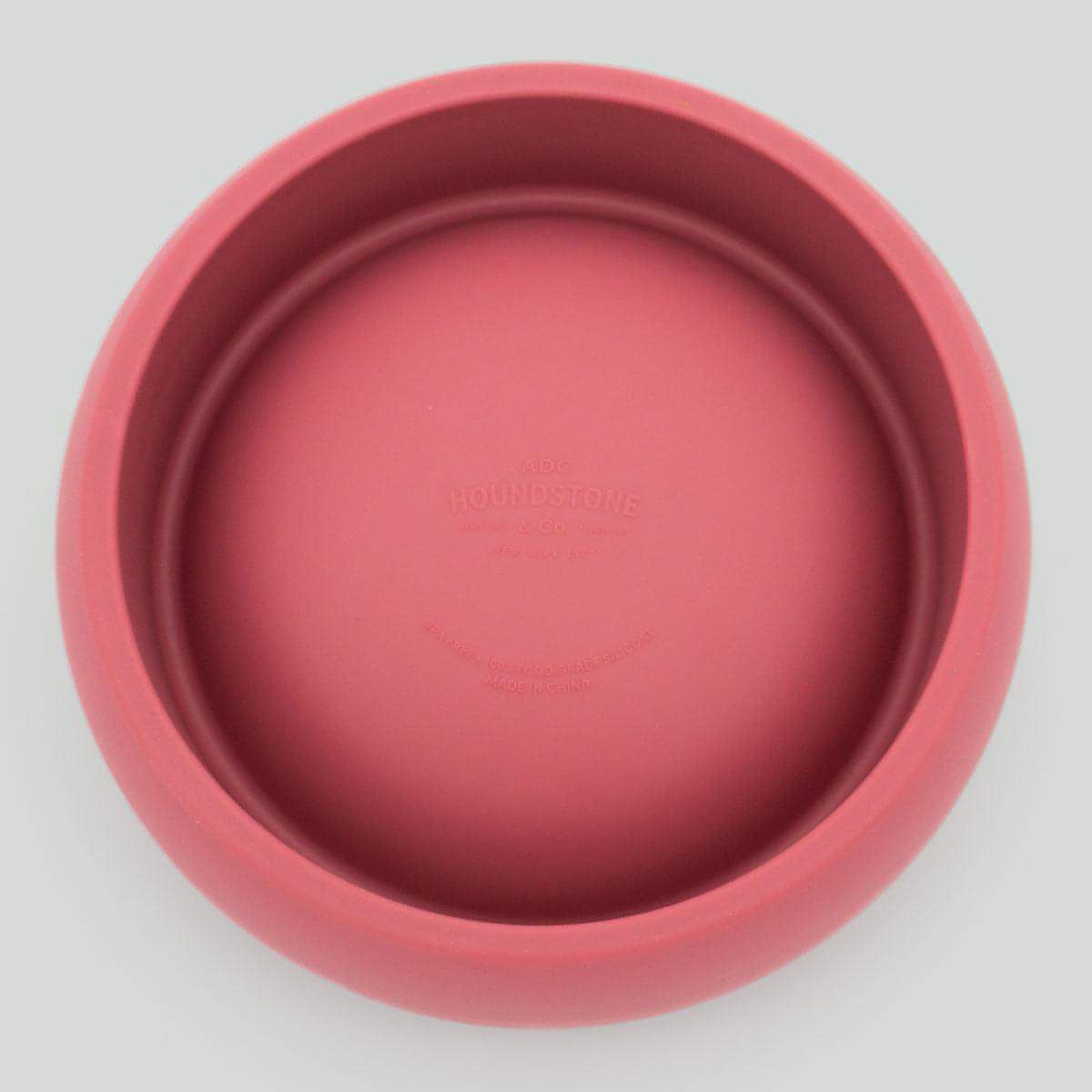 Pink silicone dog bowl on a light gray background