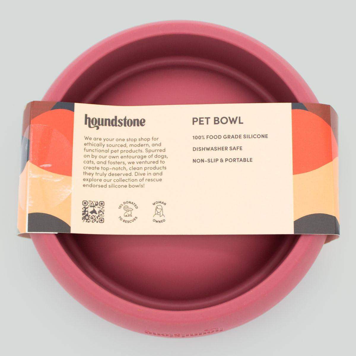 Pink dog food bowl with 'houndstone' label on a gray background