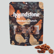 Houndstone chicken crunch dehydrated dog treats package with chicken illustrations on a dark background