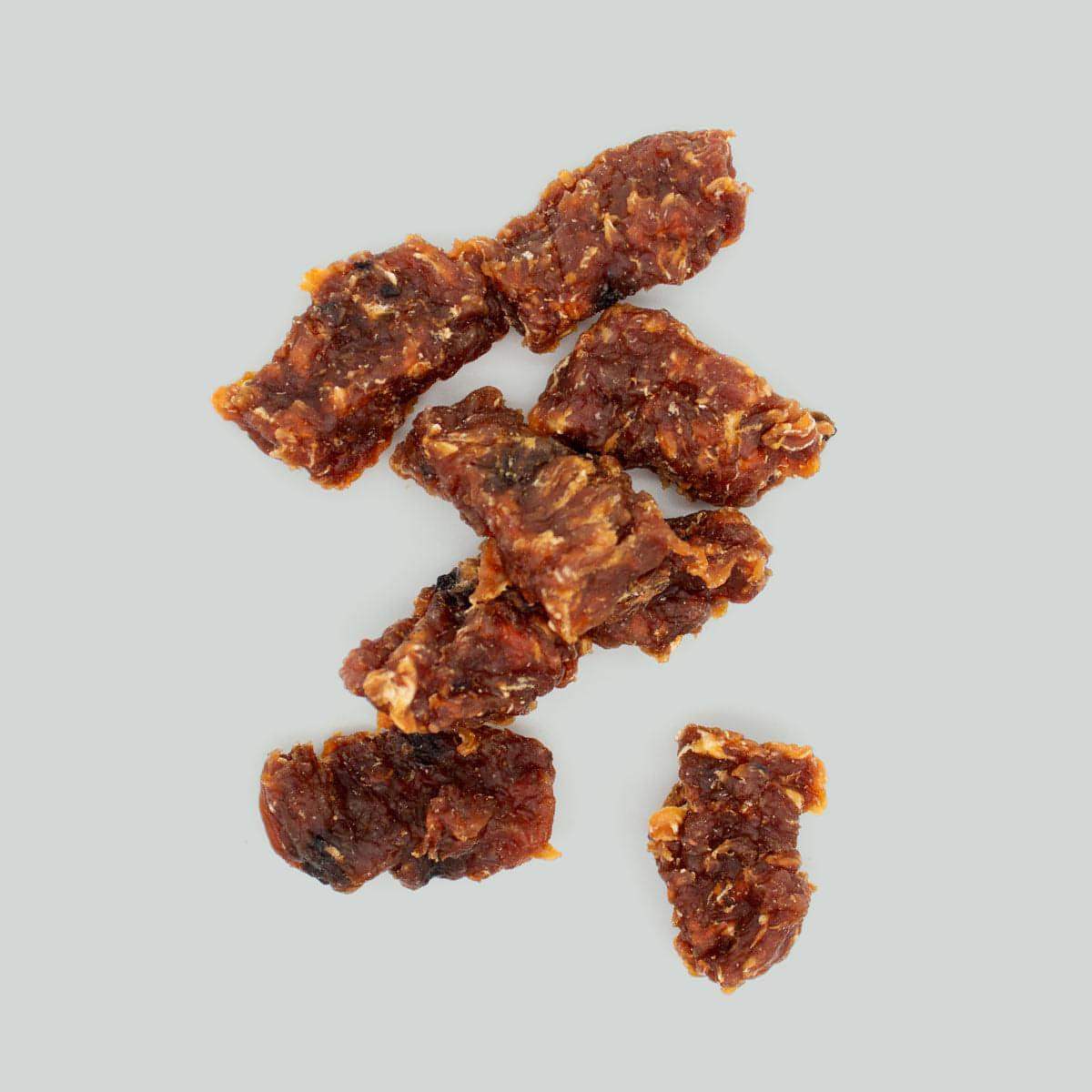 Houndstone chicken crunch low fat dog treats pieces on a gray background